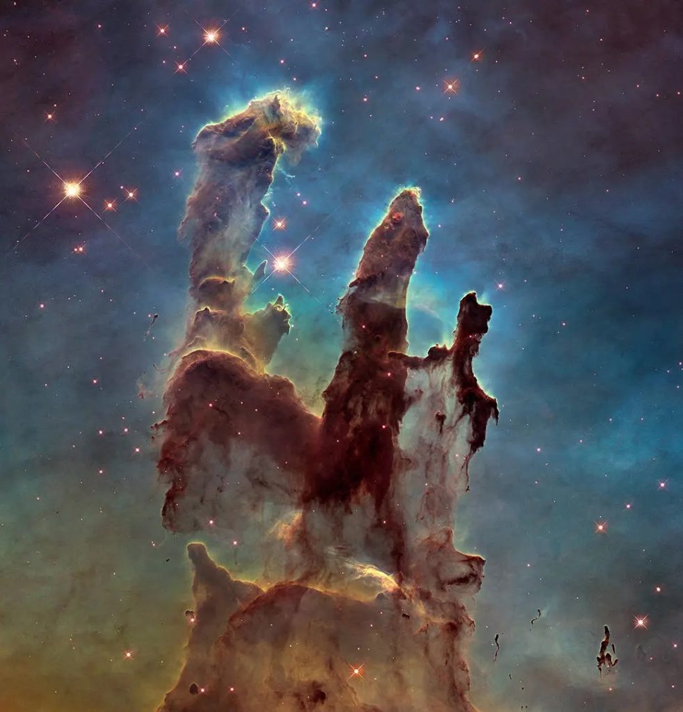 These towering tendrils of cosmic dust and gas sit at the heart of M16, or the Eagle Nebula. The aptly named Pillars of Creation, featured in this stunning Hubble image, are part of an active star-forming region within the nebula and hide newborn stars in their wispy columns.